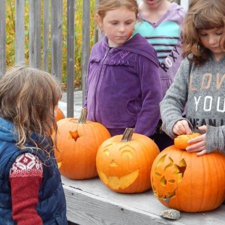 Children carving pumpkins Children carving pumpkins